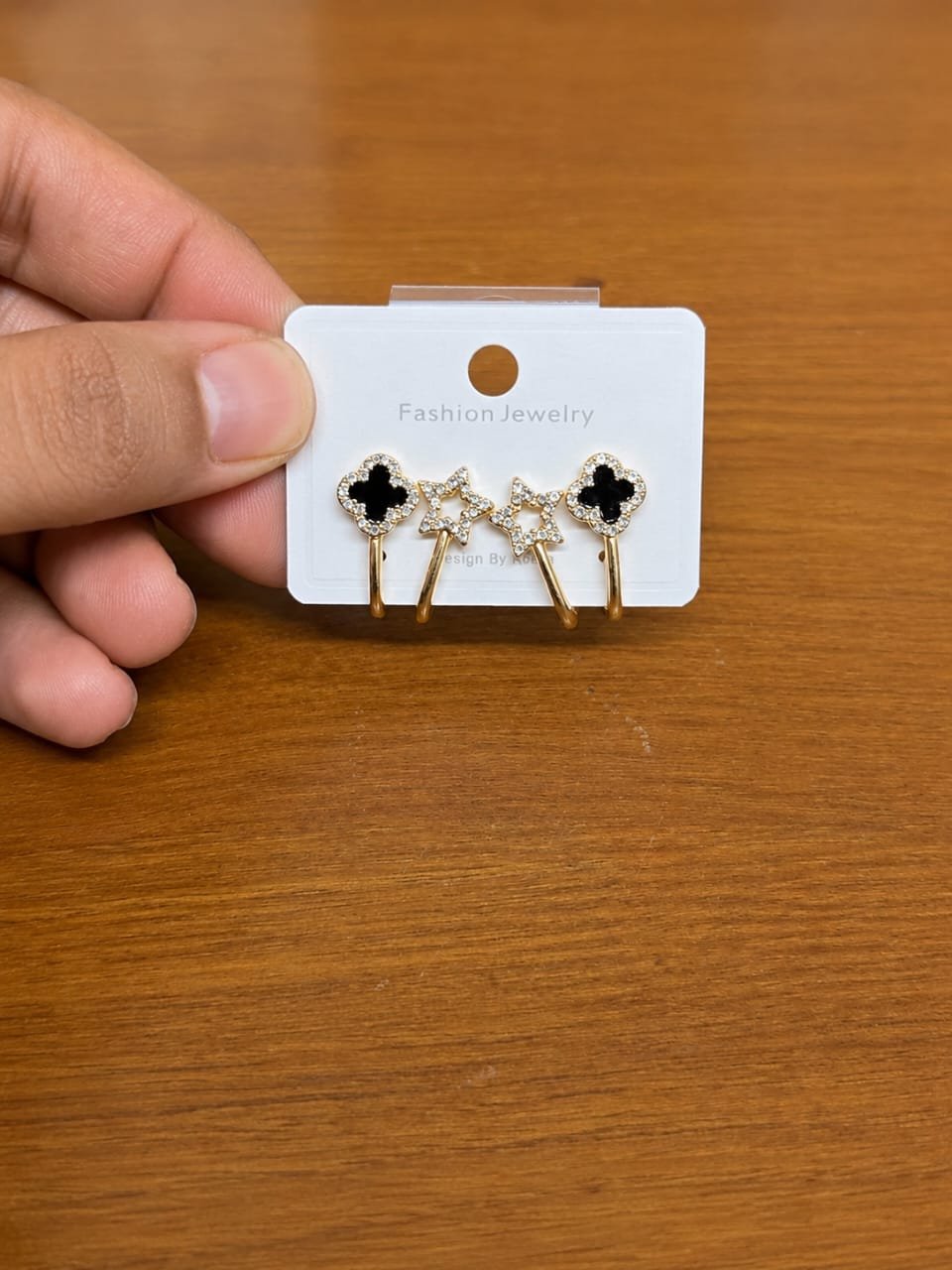 Black Clover Ear Jacket Earrings in gold-tone style with black clover studs with clear star ear-jacket details