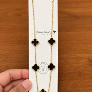 Gold-tone necklace with five black clover motifs