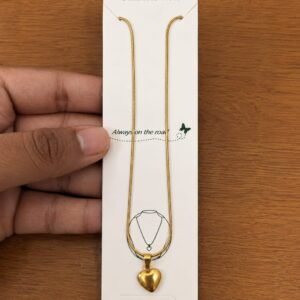 Gold-tone necklace with a small polished puffy heart pendant