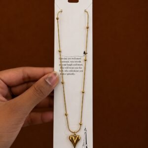 Gold-tone textured heart pendant necklace on a ball-station chain