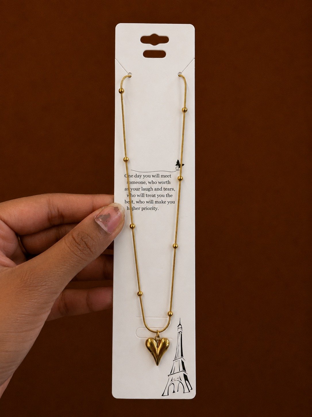 Gold-tone textured heart pendant necklace on a ball-station chain