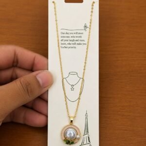 Gold-tone pink flower necklace with a large pearl-like center
