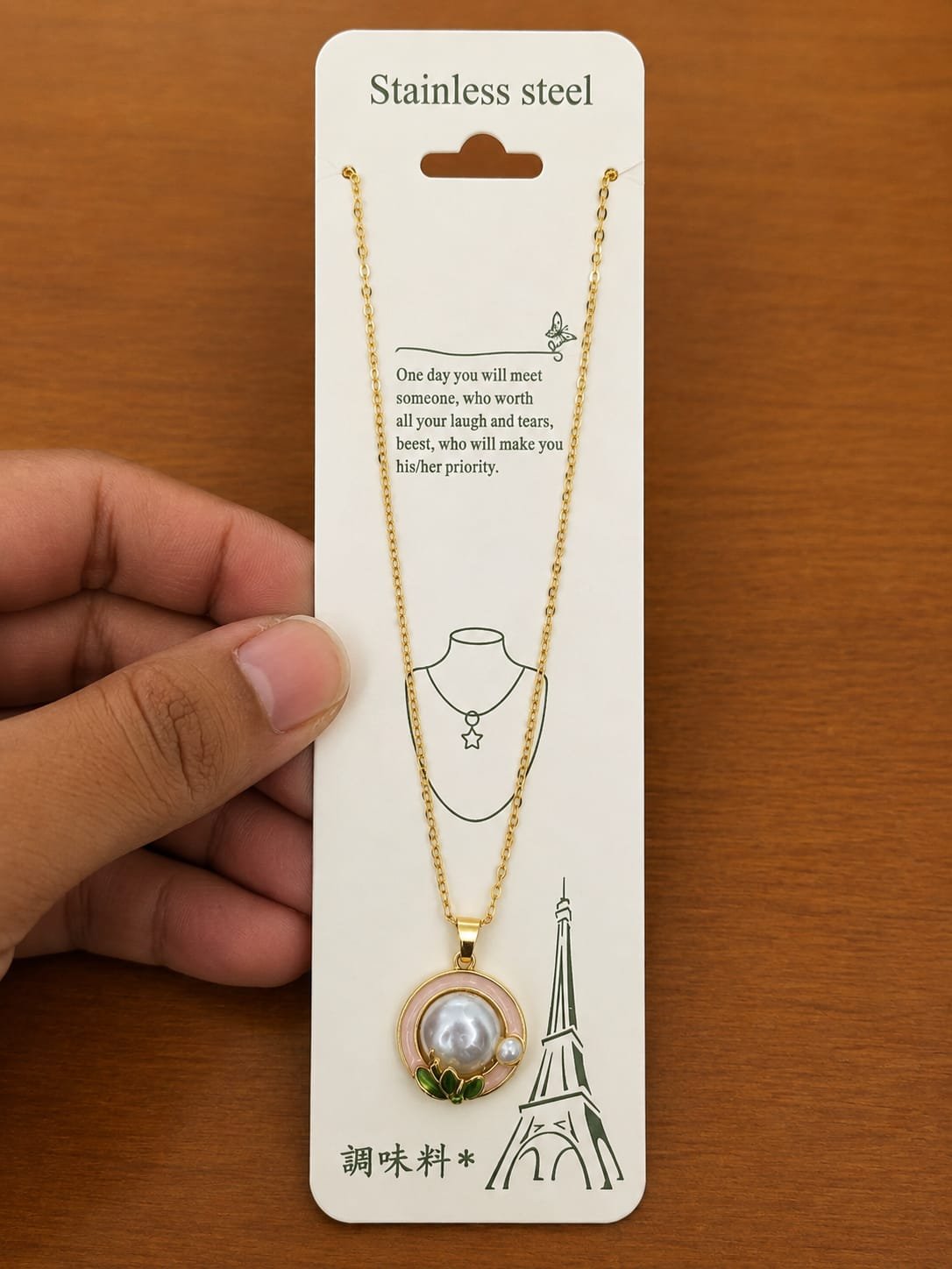 Gold-tone pink flower necklace with a large pearl-like center