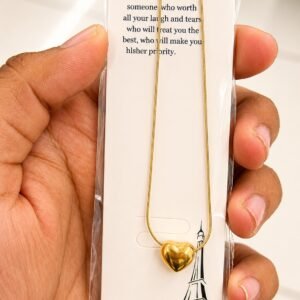 Gold-tone puffy heart necklace on a snake chain