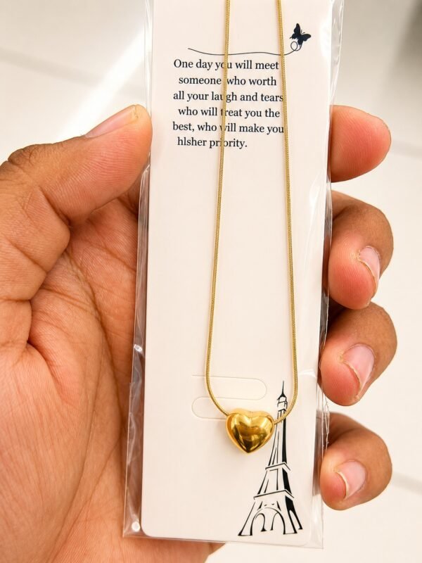 Gold-tone puffy heart necklace on a snake chain