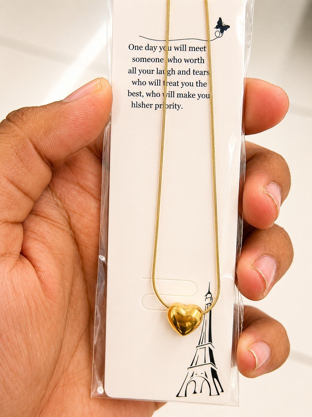 Gold-tone puffy heart necklace on a snake chain
