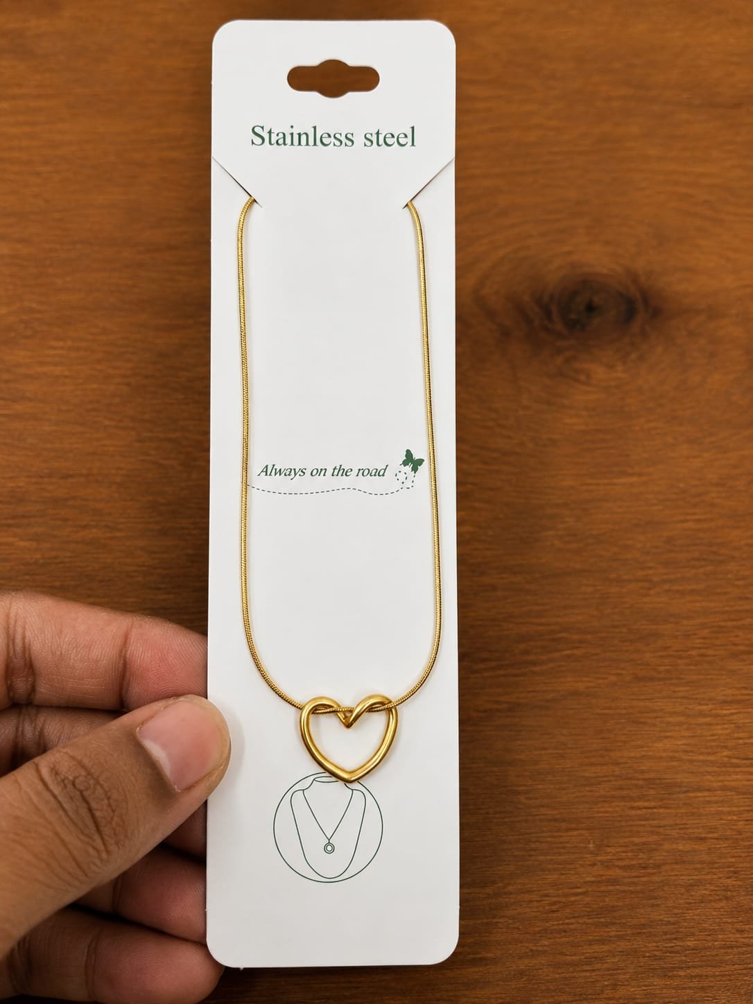 Gold-tone heart knot necklace with an open outline design