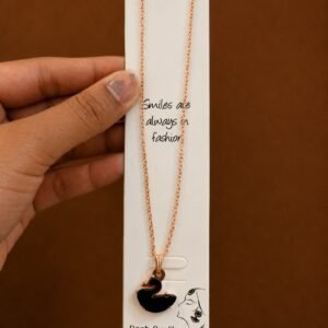 Rose gold-tone necklace with a glossy black swan pendant