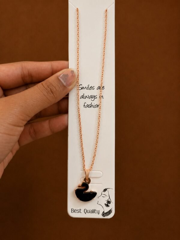 Rose gold-tone necklace with a glossy black swan pendant